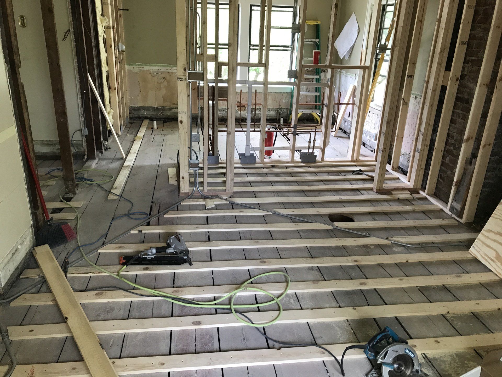 A wooden floor is being built in a house.