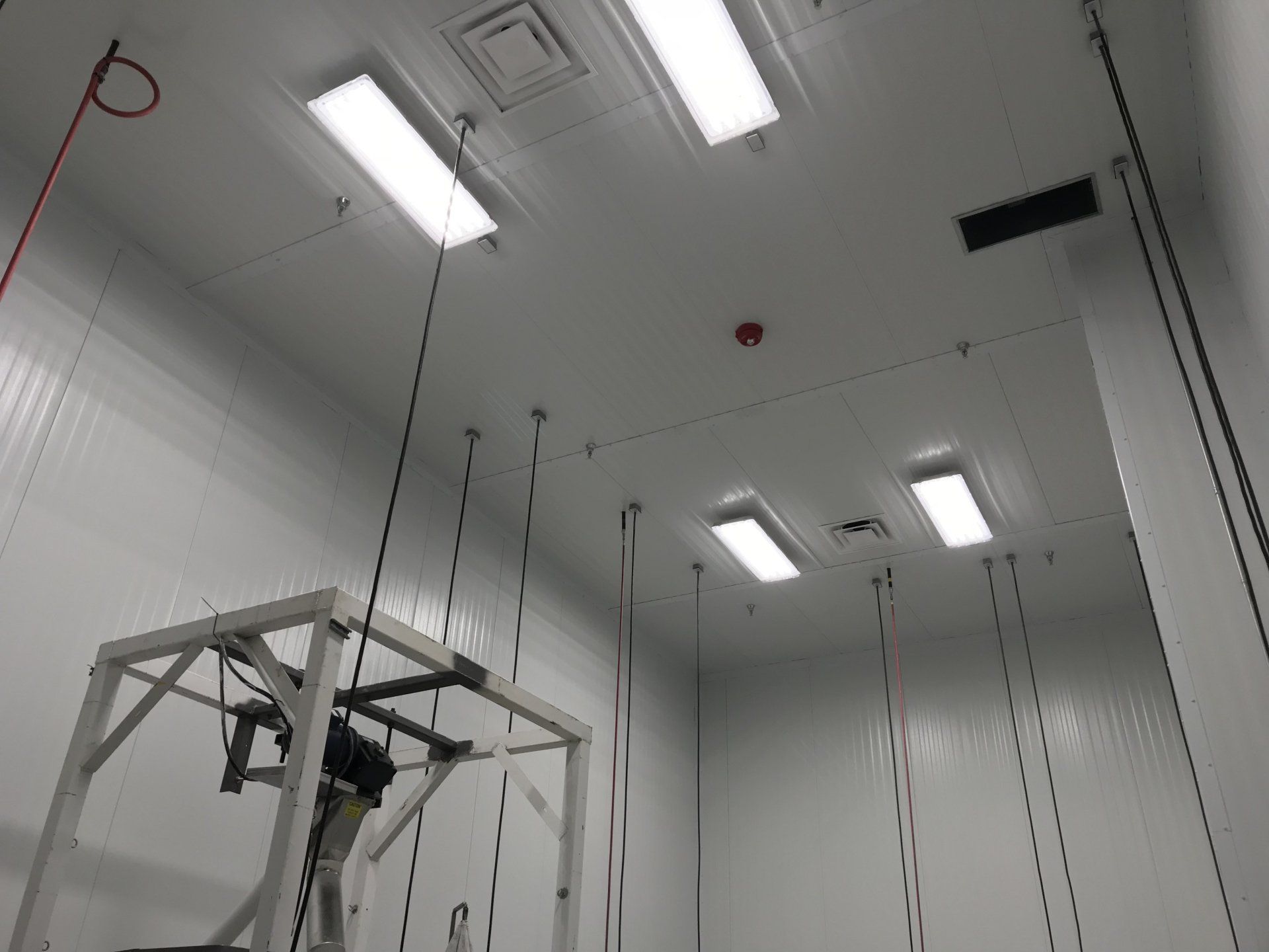 A room with a lot of lights hanging from the ceiling