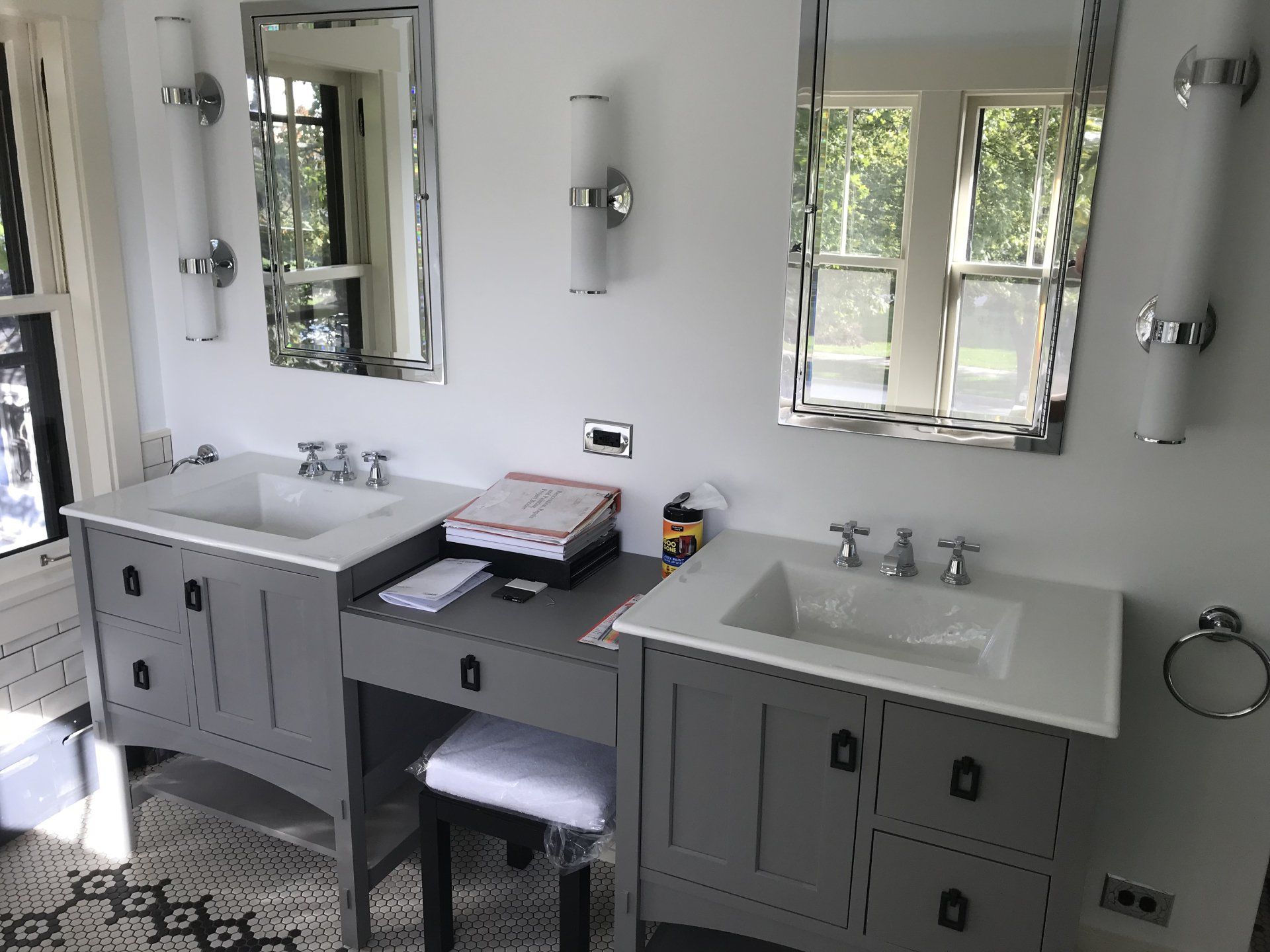 A bathroom with two sinks and two mirrors