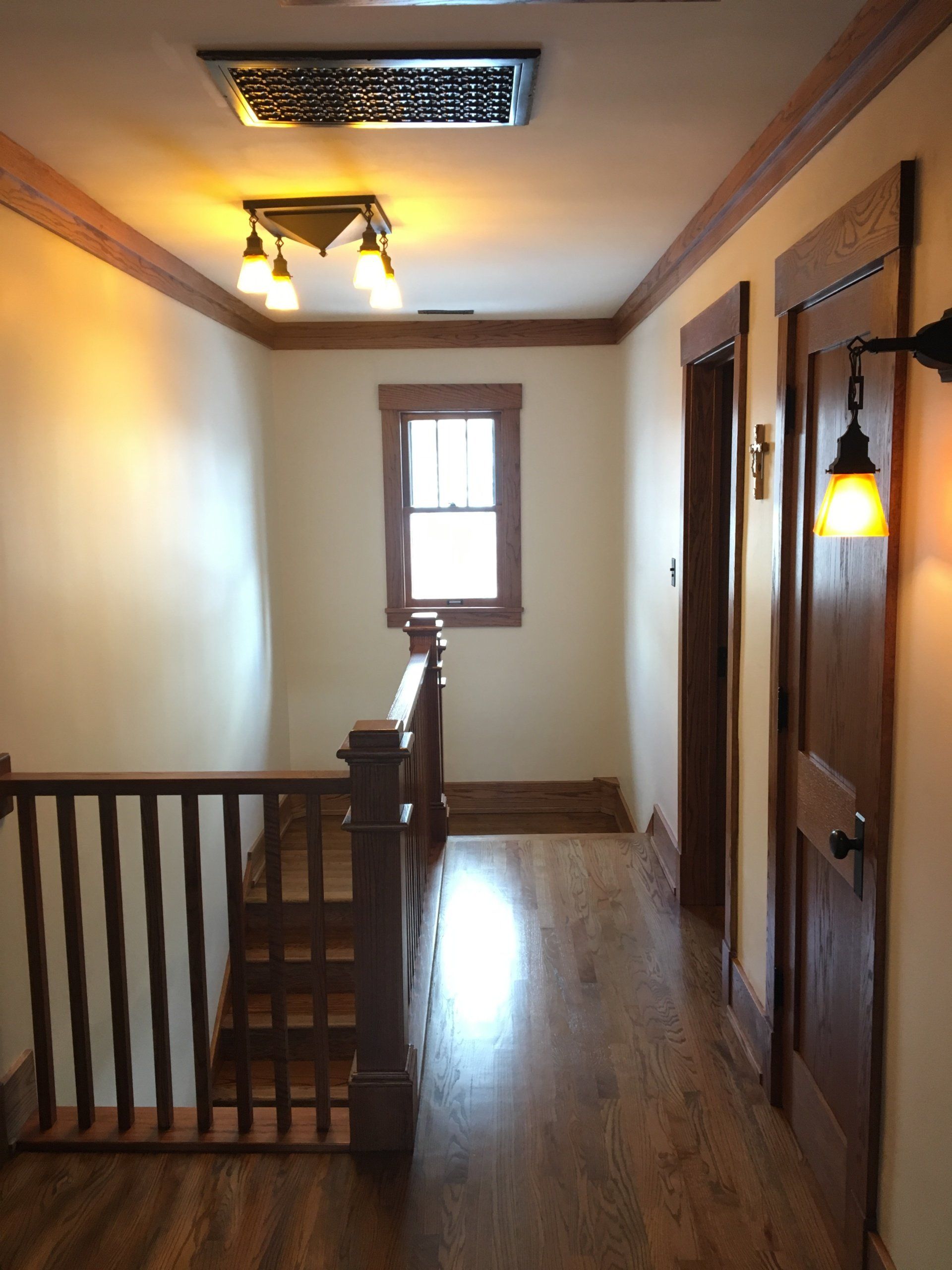 A hallway with stairs leading up to the second floor