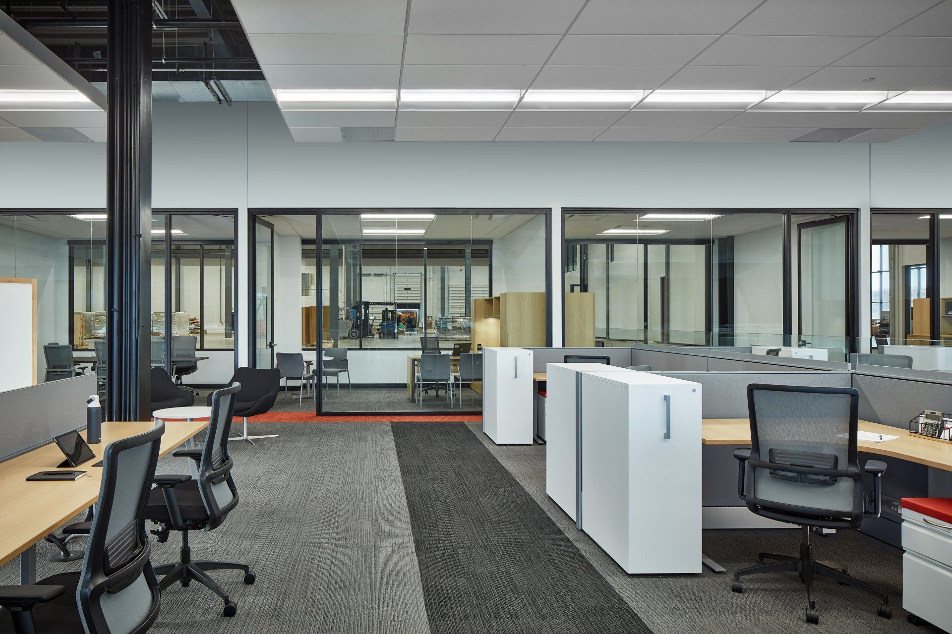 A large office with a lot of desks and chairs.