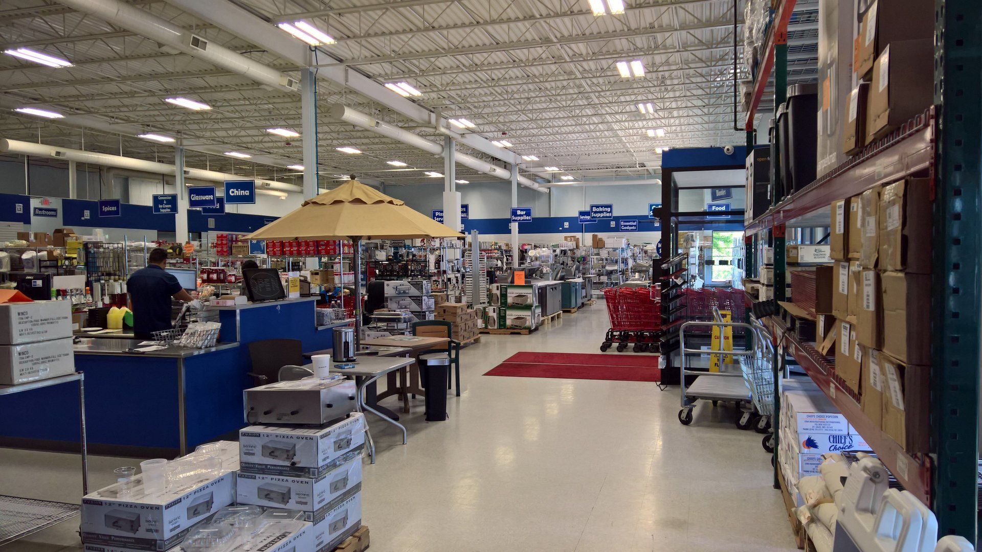 A large warehouse with lots of boxes and umbrellas
