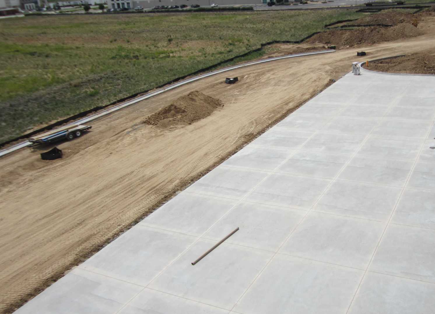 An aerial view of a construction site with a lot of dirt and concrete.