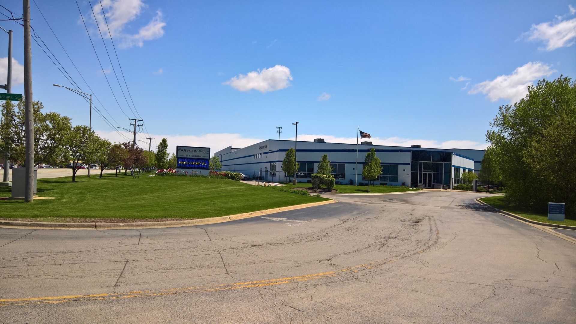 A large white building with a blue sky in the background