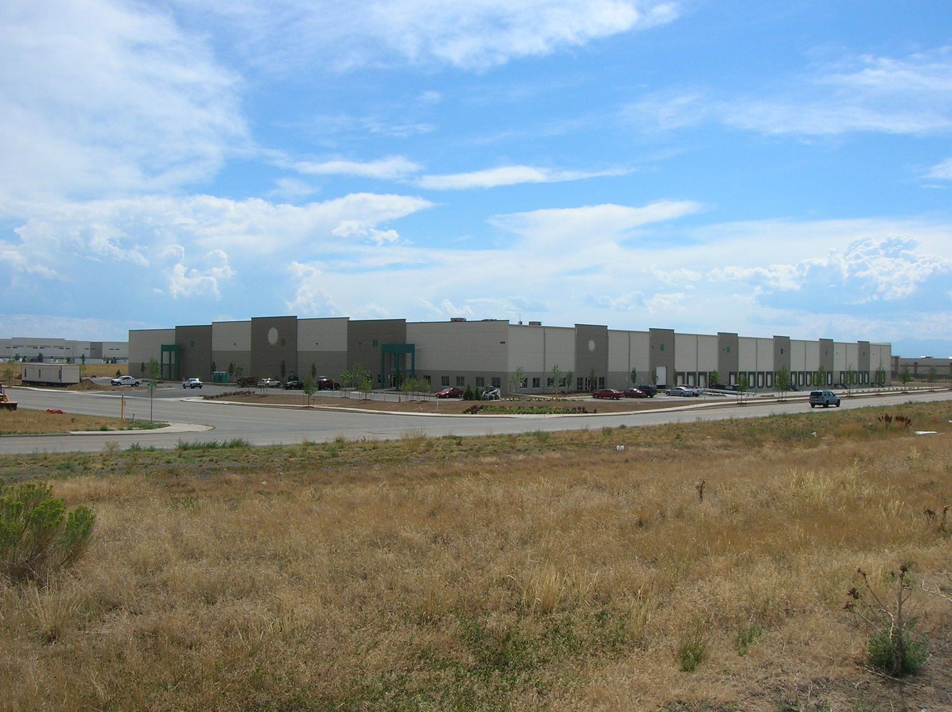 A large building is sitting in the middle of a field