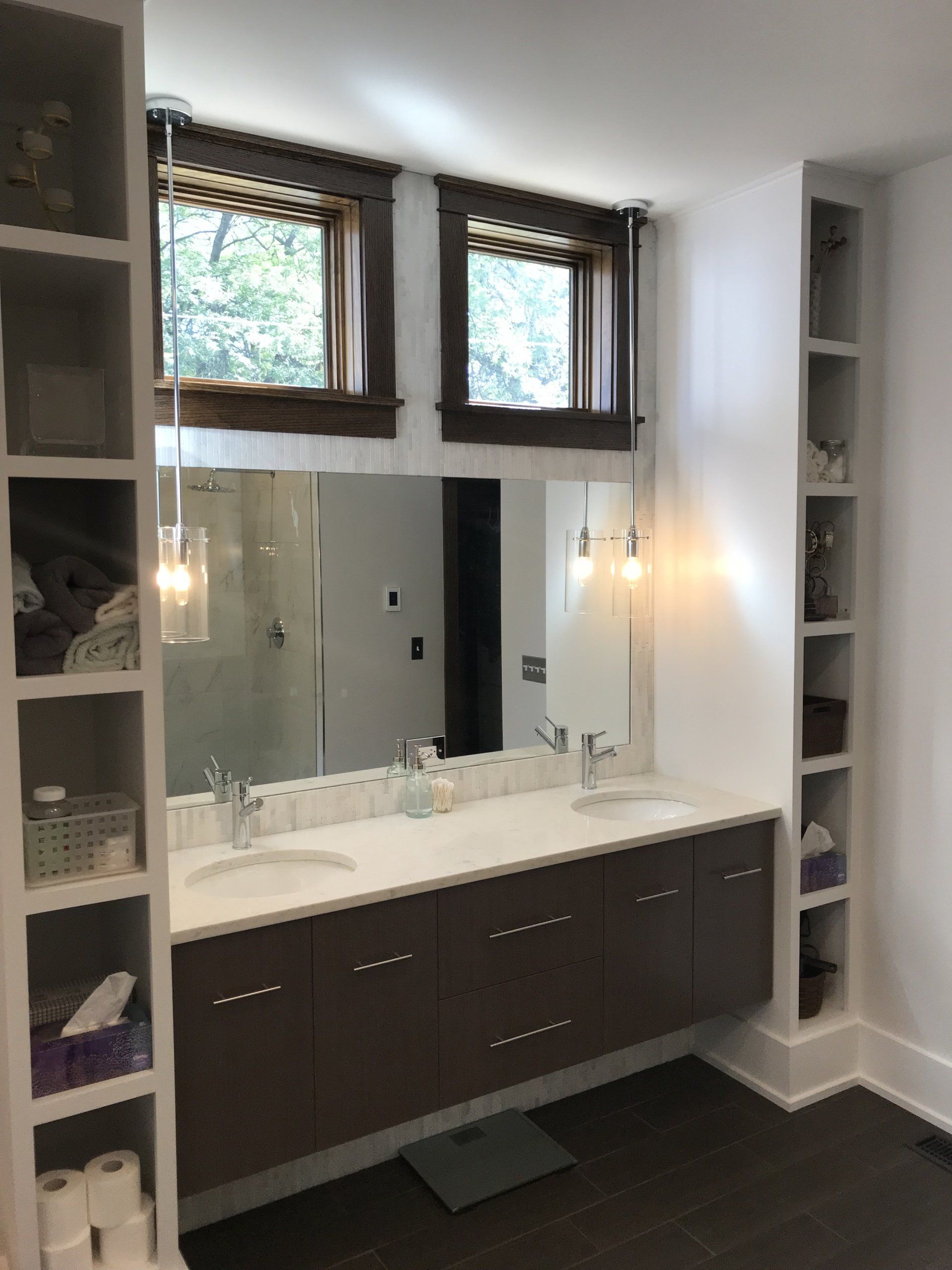 A bathroom with two sinks and a large mirror