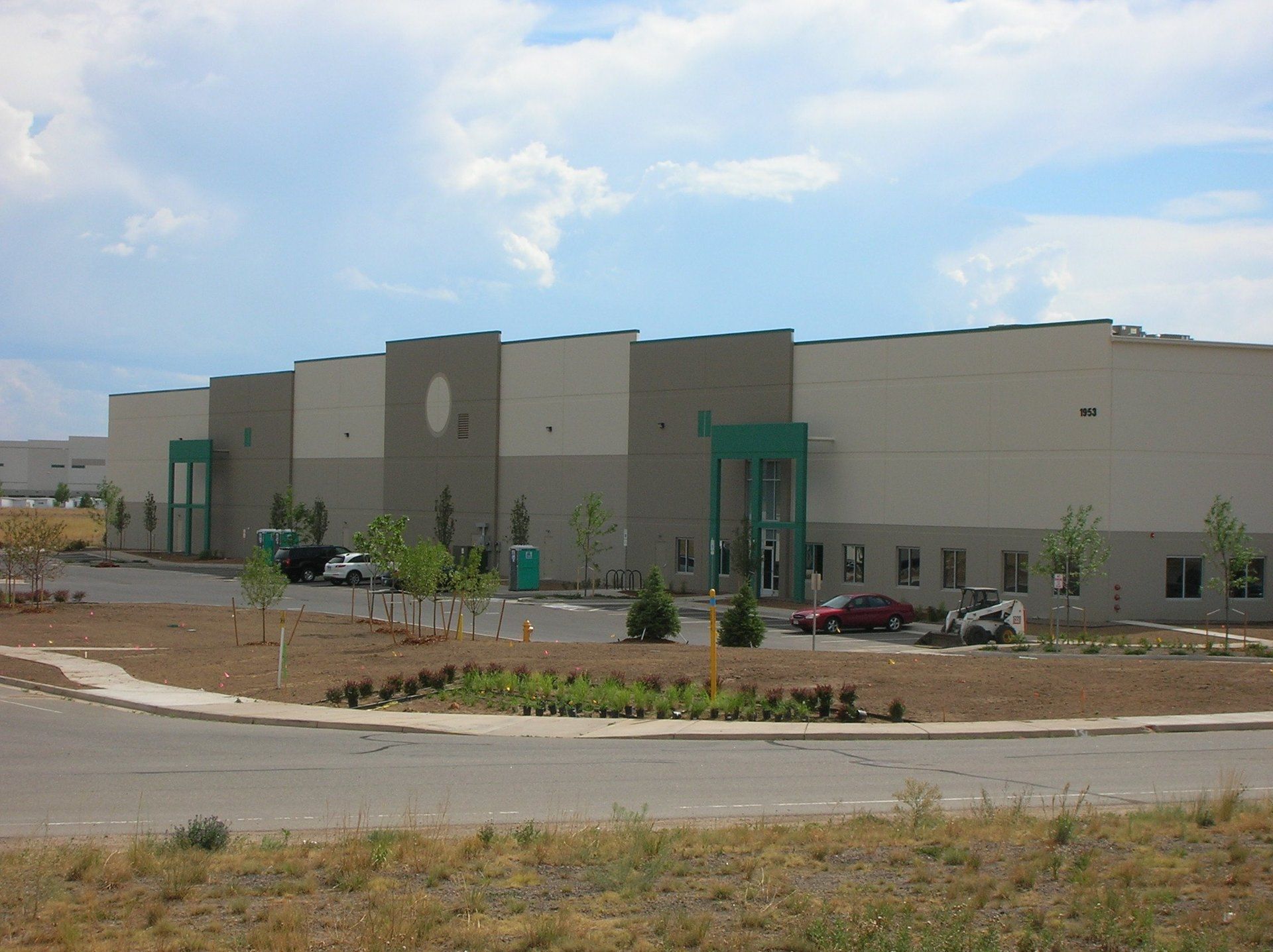 A large building with cars parked in front of it