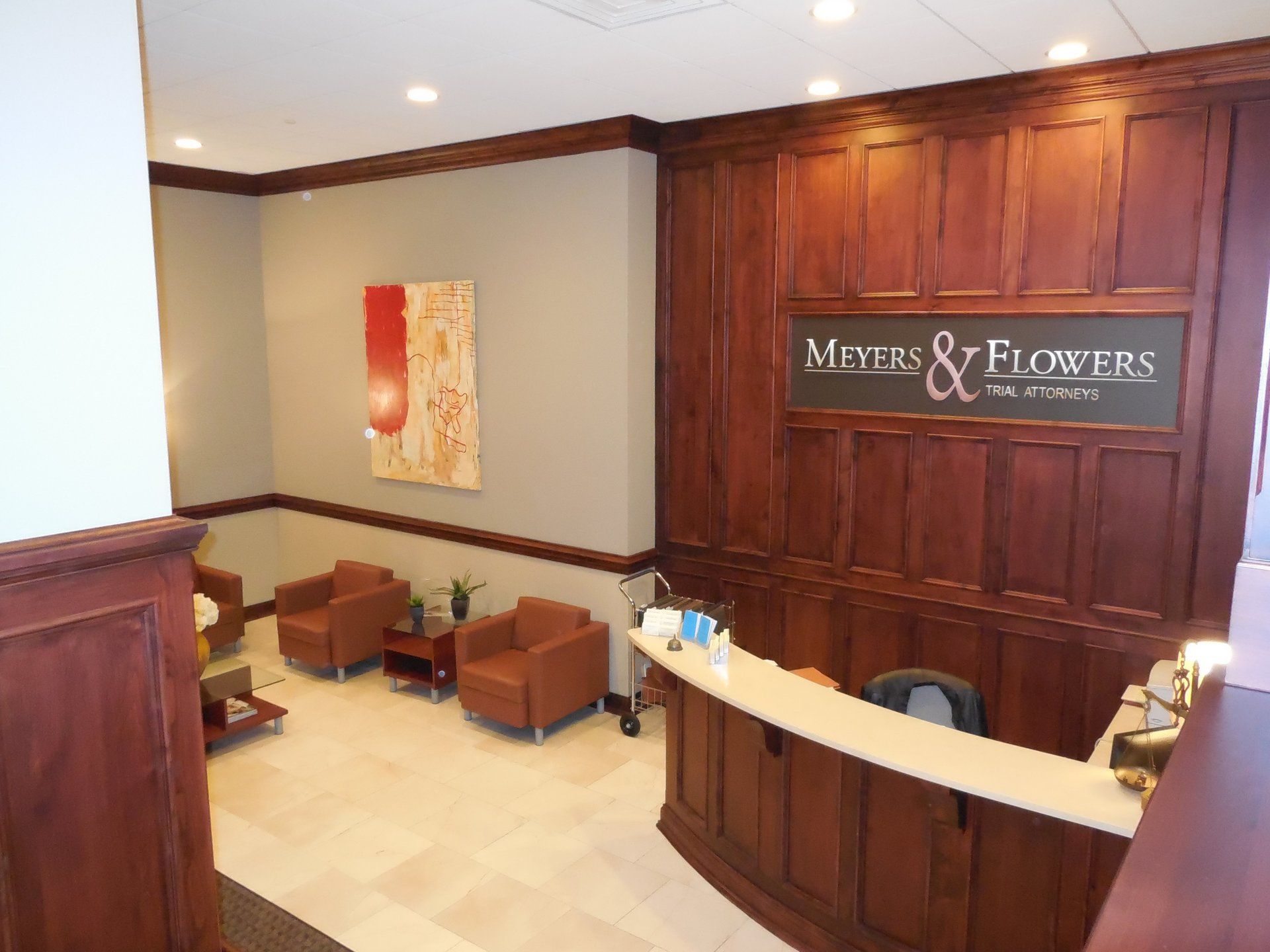 A lobby with a sign that says ' masters & flowers ' on it