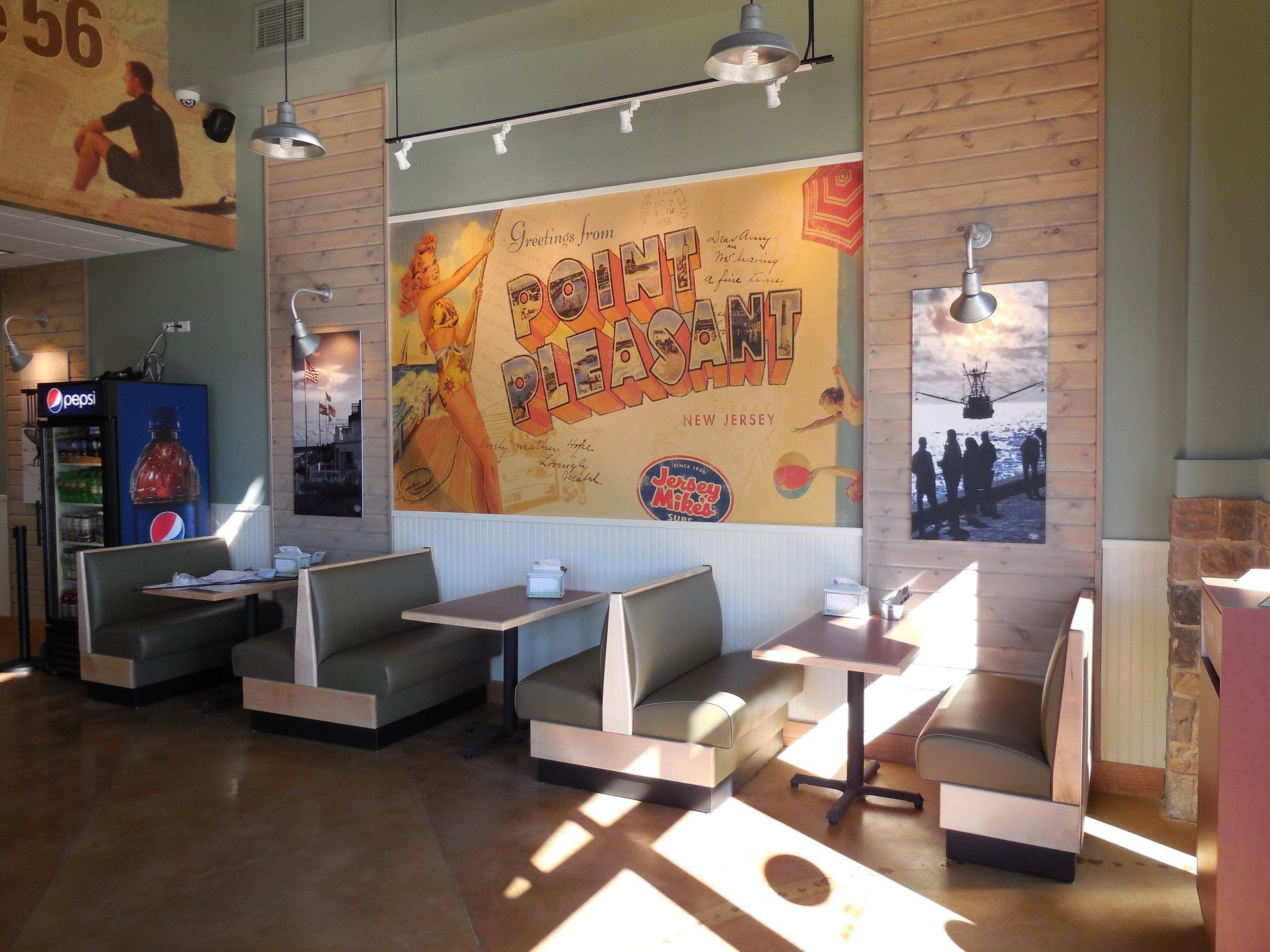 The inside of a restaurant with tables and booths