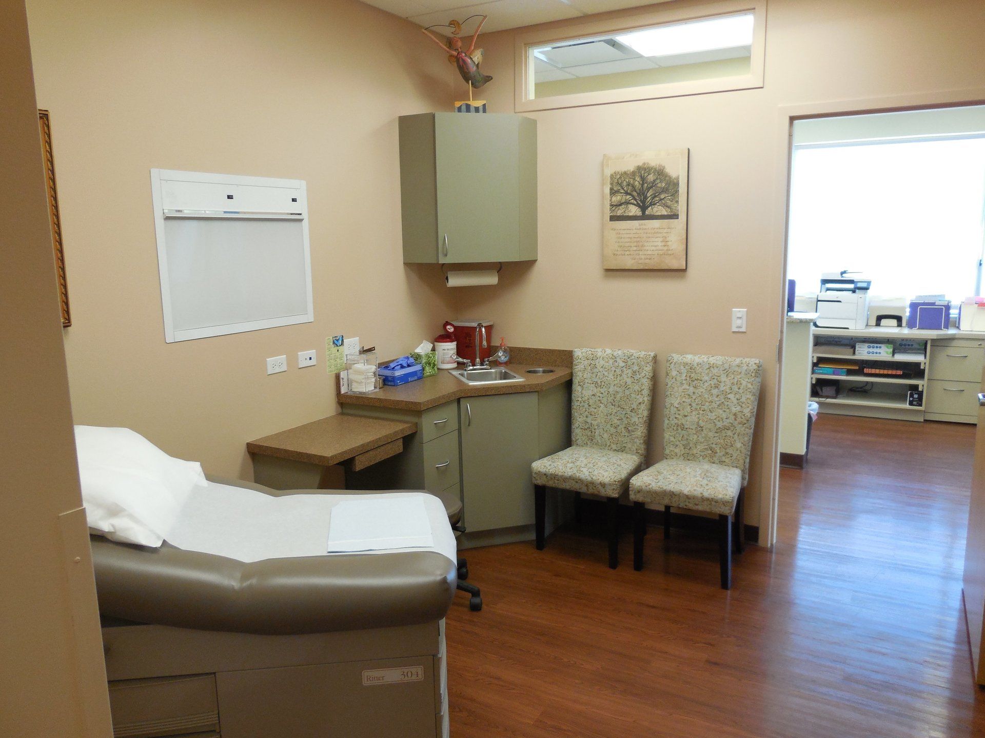 A doctor 's office with a table and chairs