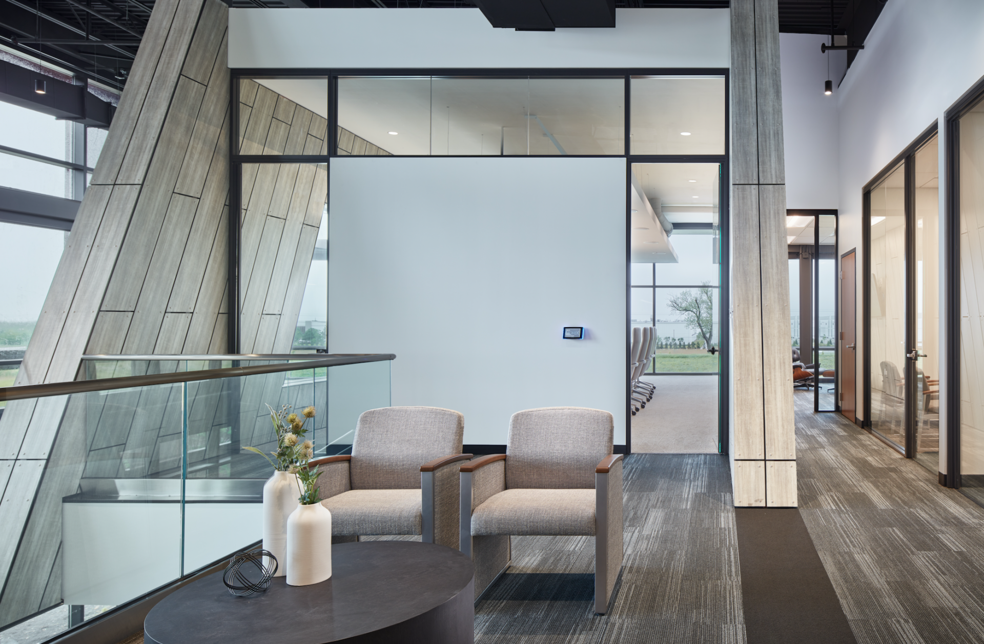 There are two chairs and a table in the room.