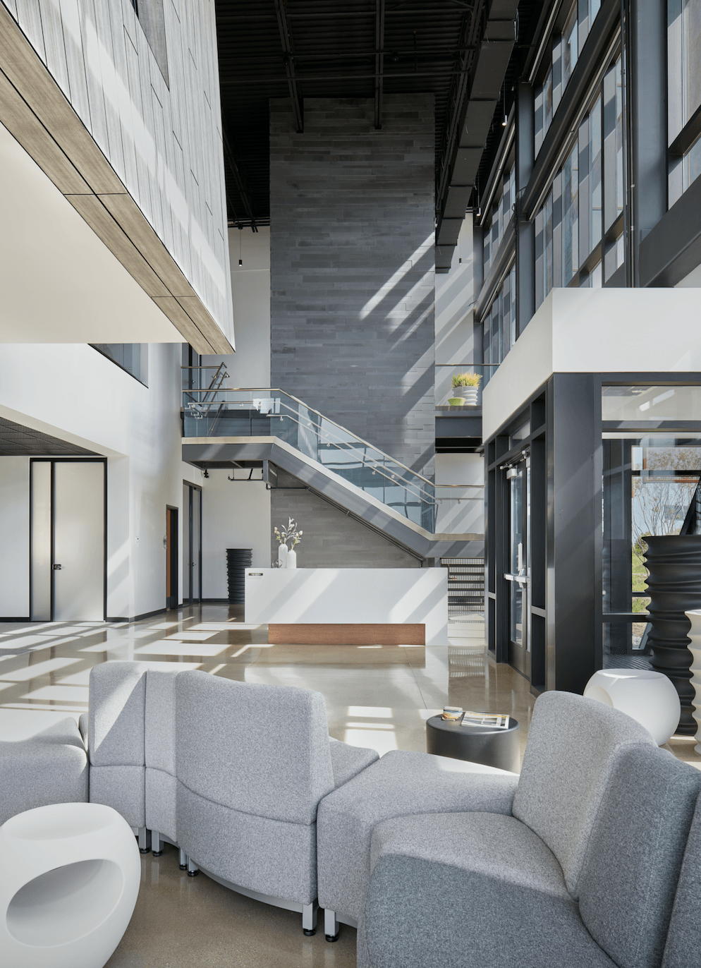 A large lobby with a staircase and a reception desk