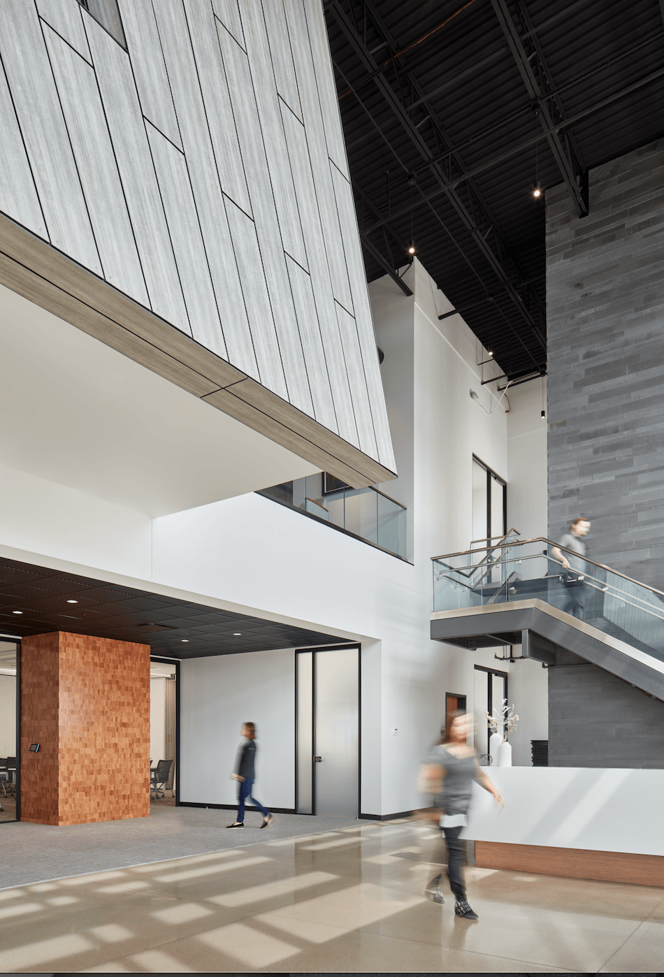 A group of people are walking through a large building.