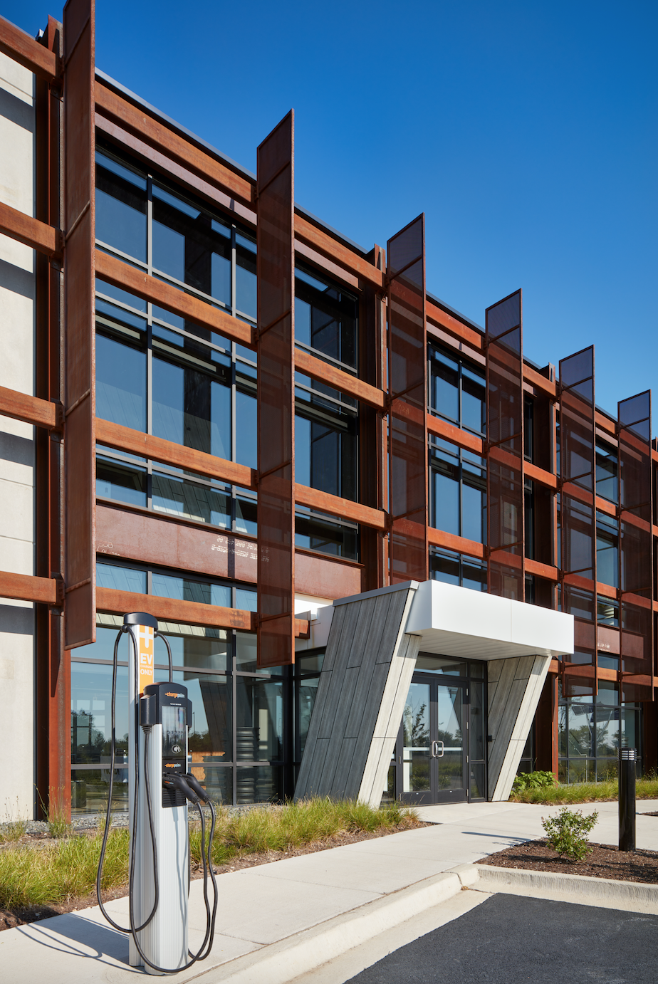 A building with a charging station in front of it