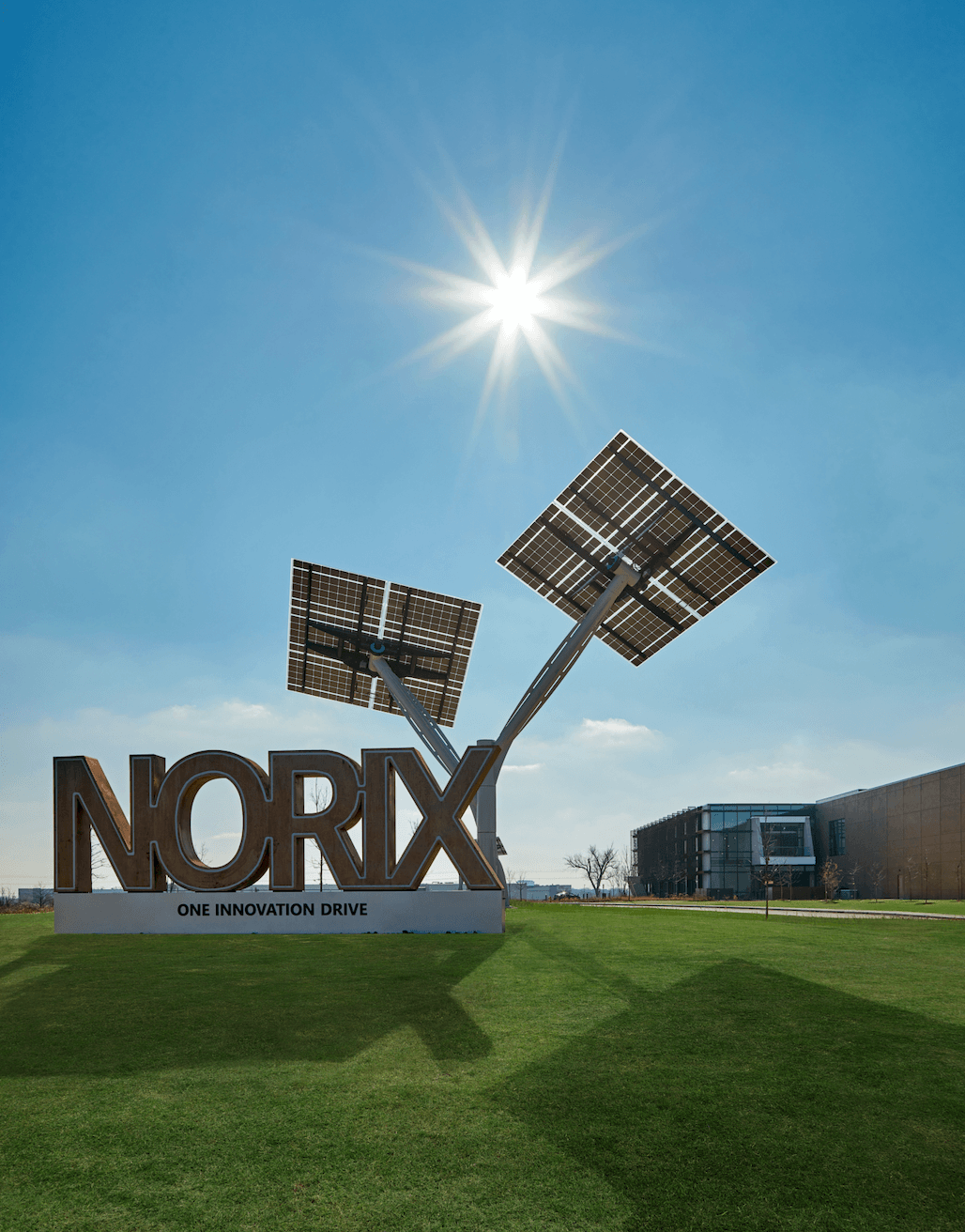 A norx sign with two solar panels in front of it