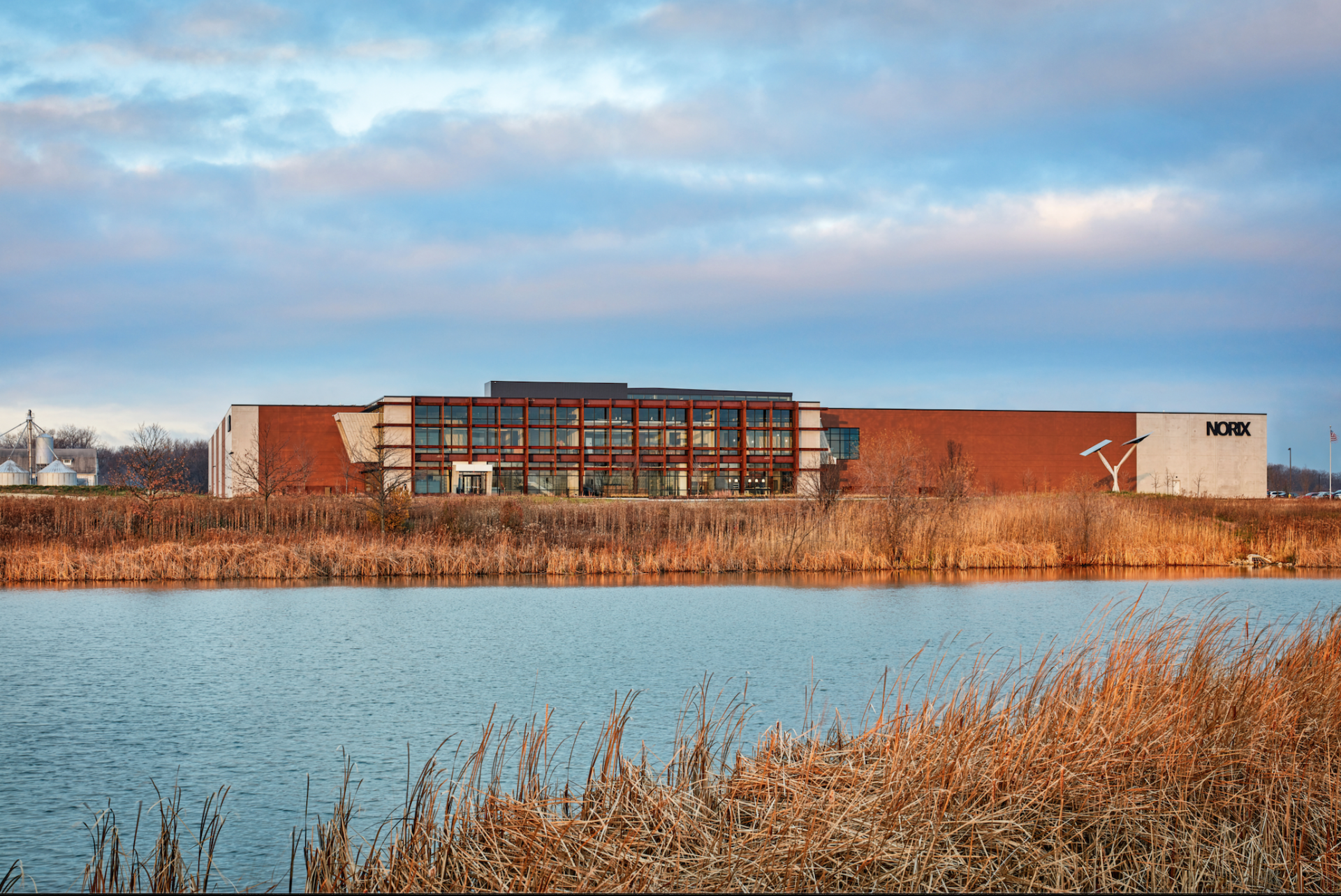 A large building is sitting next to a body of water.