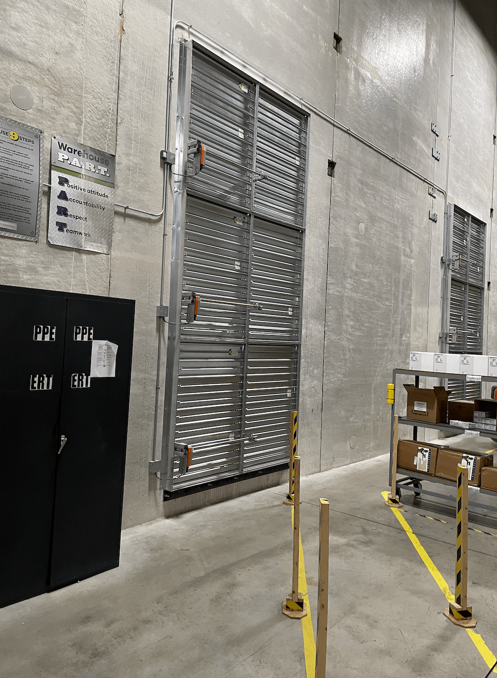 A large room with a lot of windows and boxes on the floor.