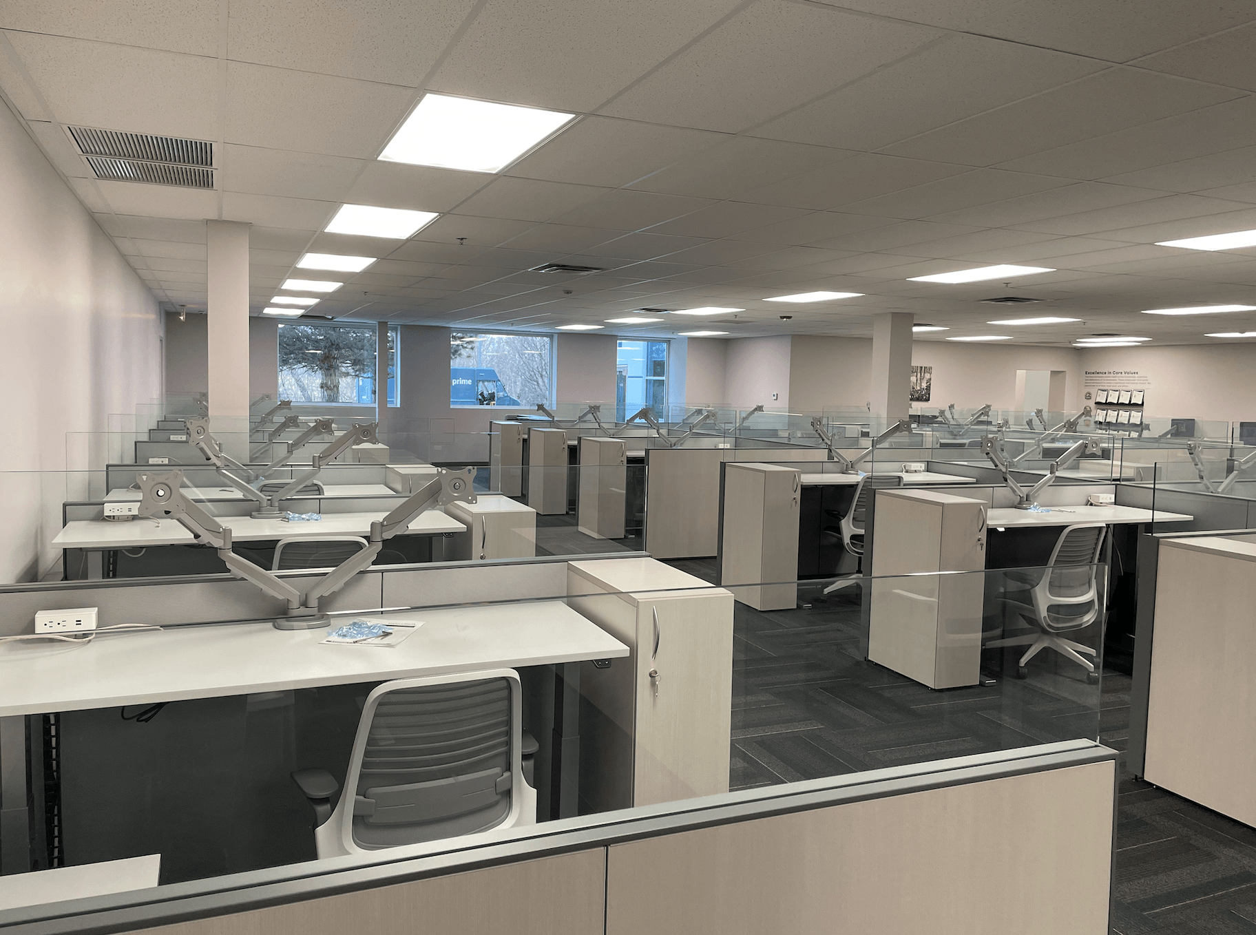 A large office with lots of cubicles and desks.