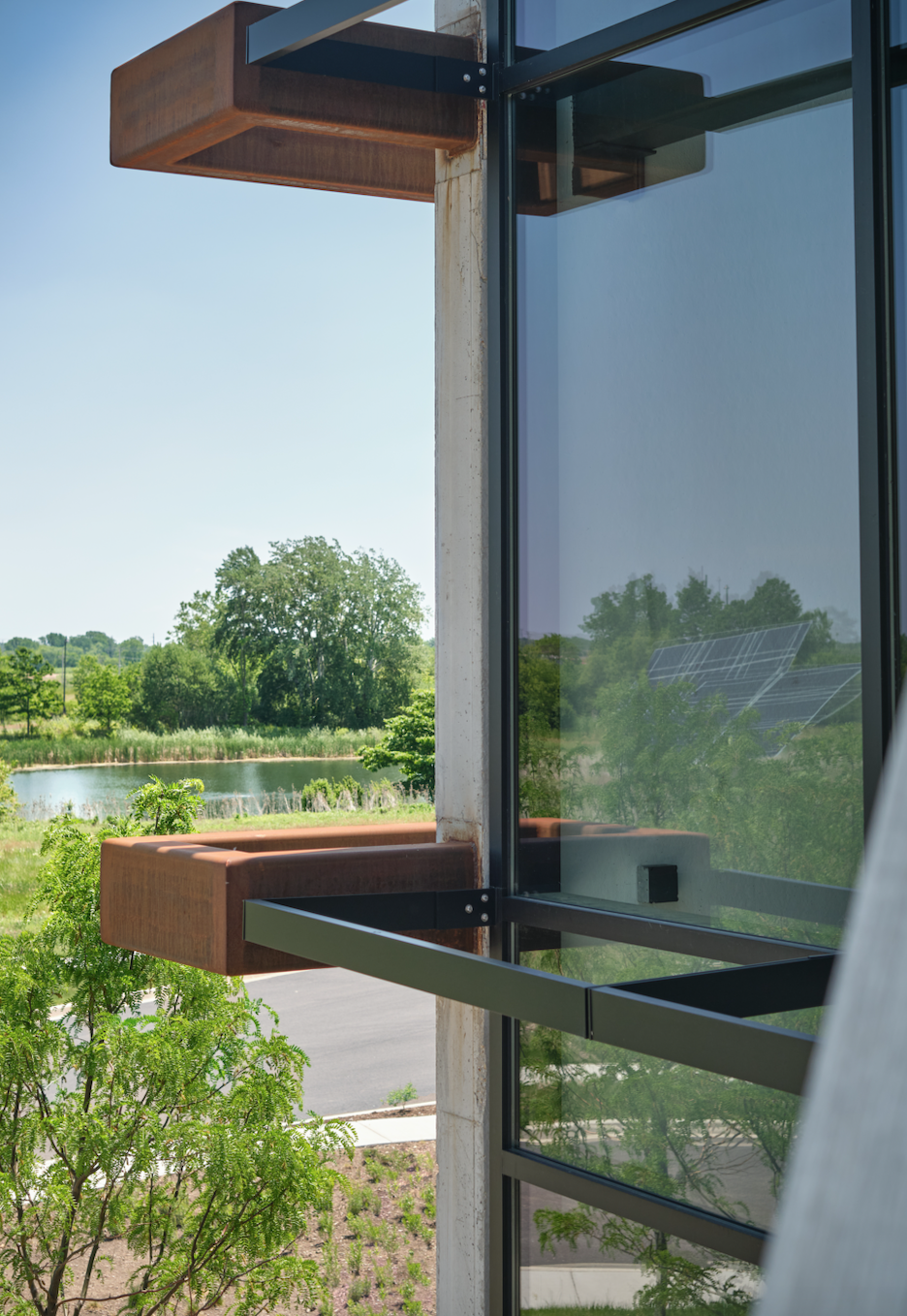 A building with a lot of windows and trees in the background.