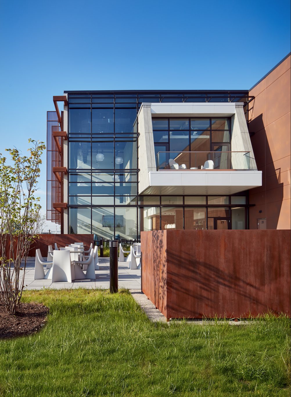 A large building with a lot of windows and a fence in front of it.