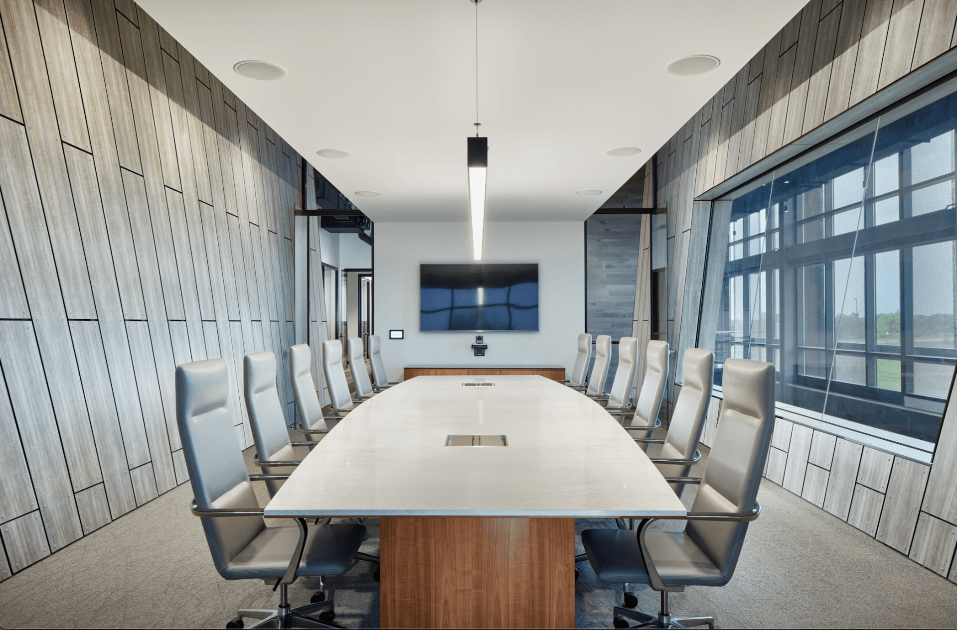 A large conference room with a long table and chairs.