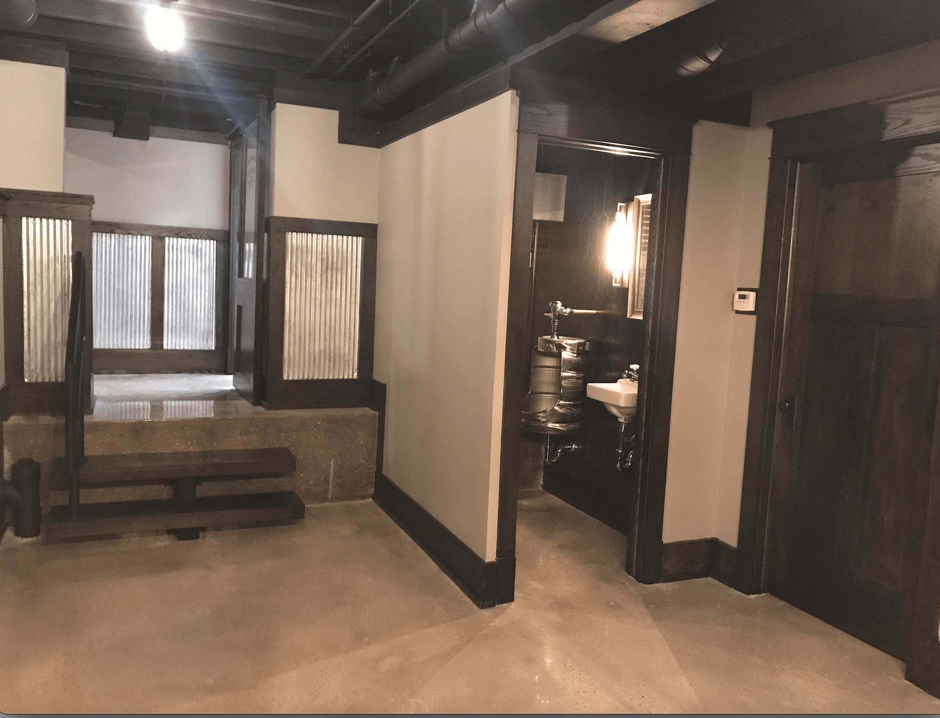 An empty room with a sink in the middle of it