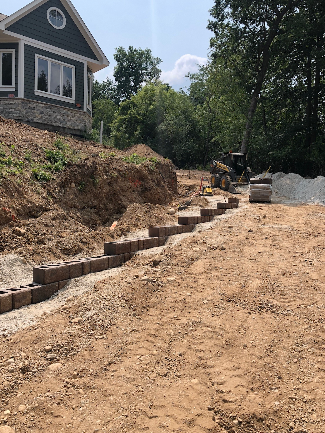 A house is being built on top of a dirt hill.