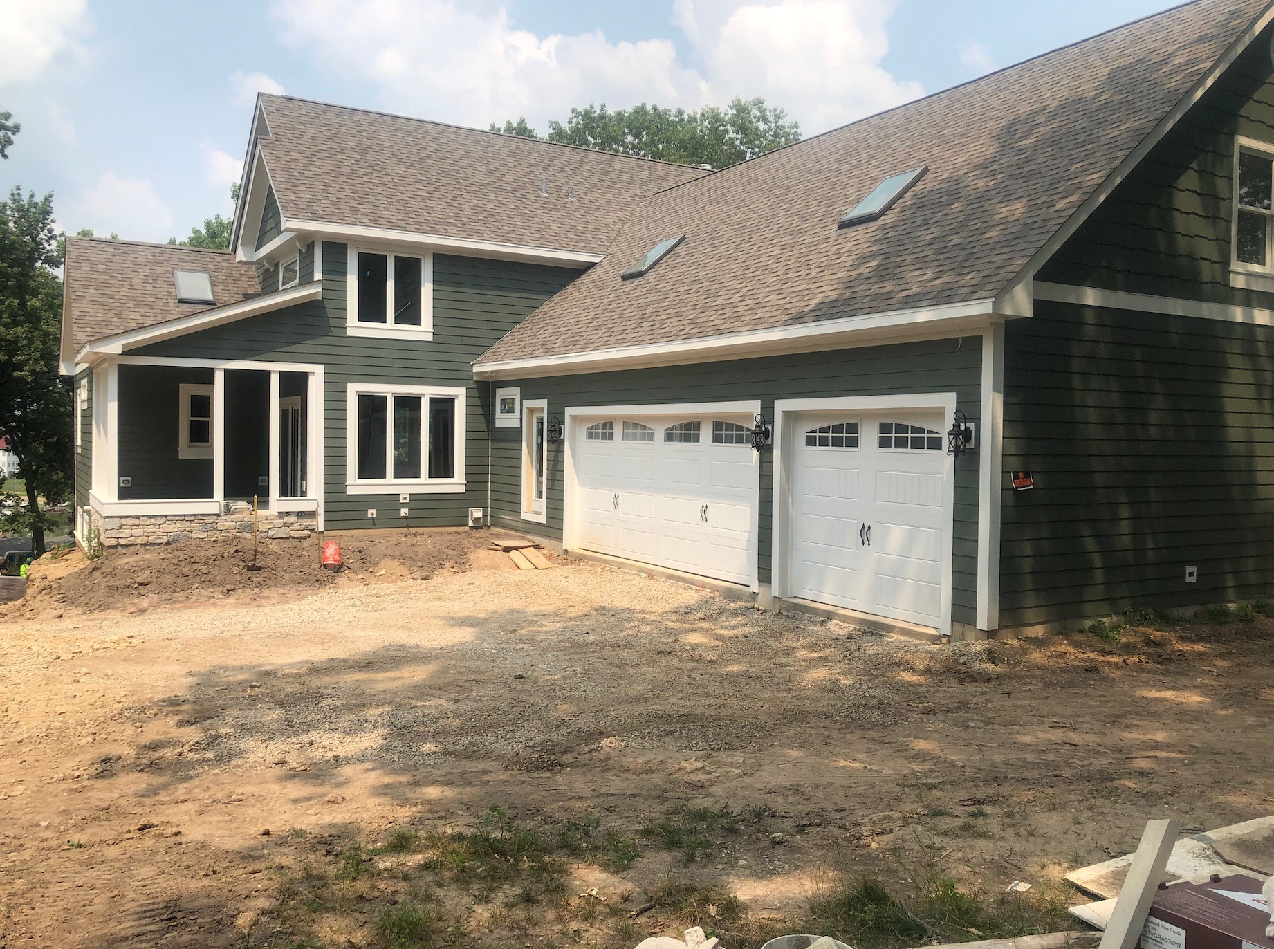 A large house with two garage doors is being built.