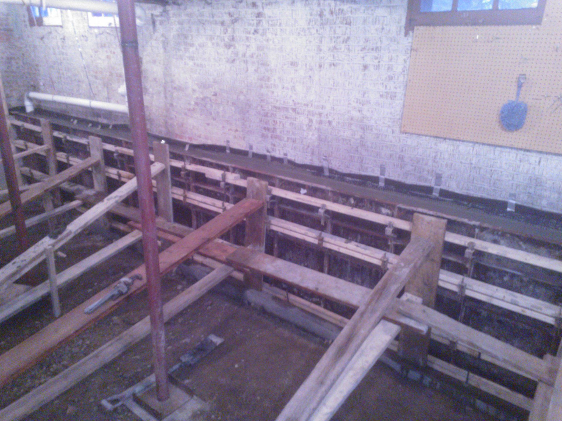 A wooden structure is being built in front of a building