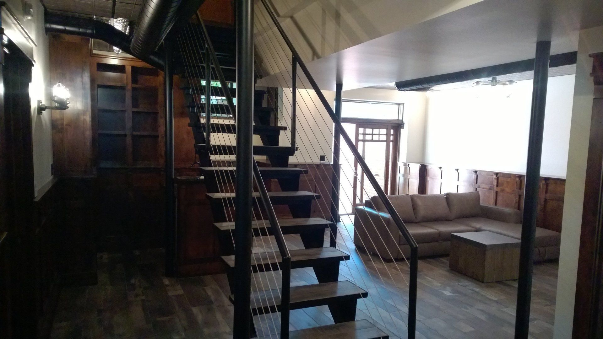 A living room with a spiral staircase and a couch