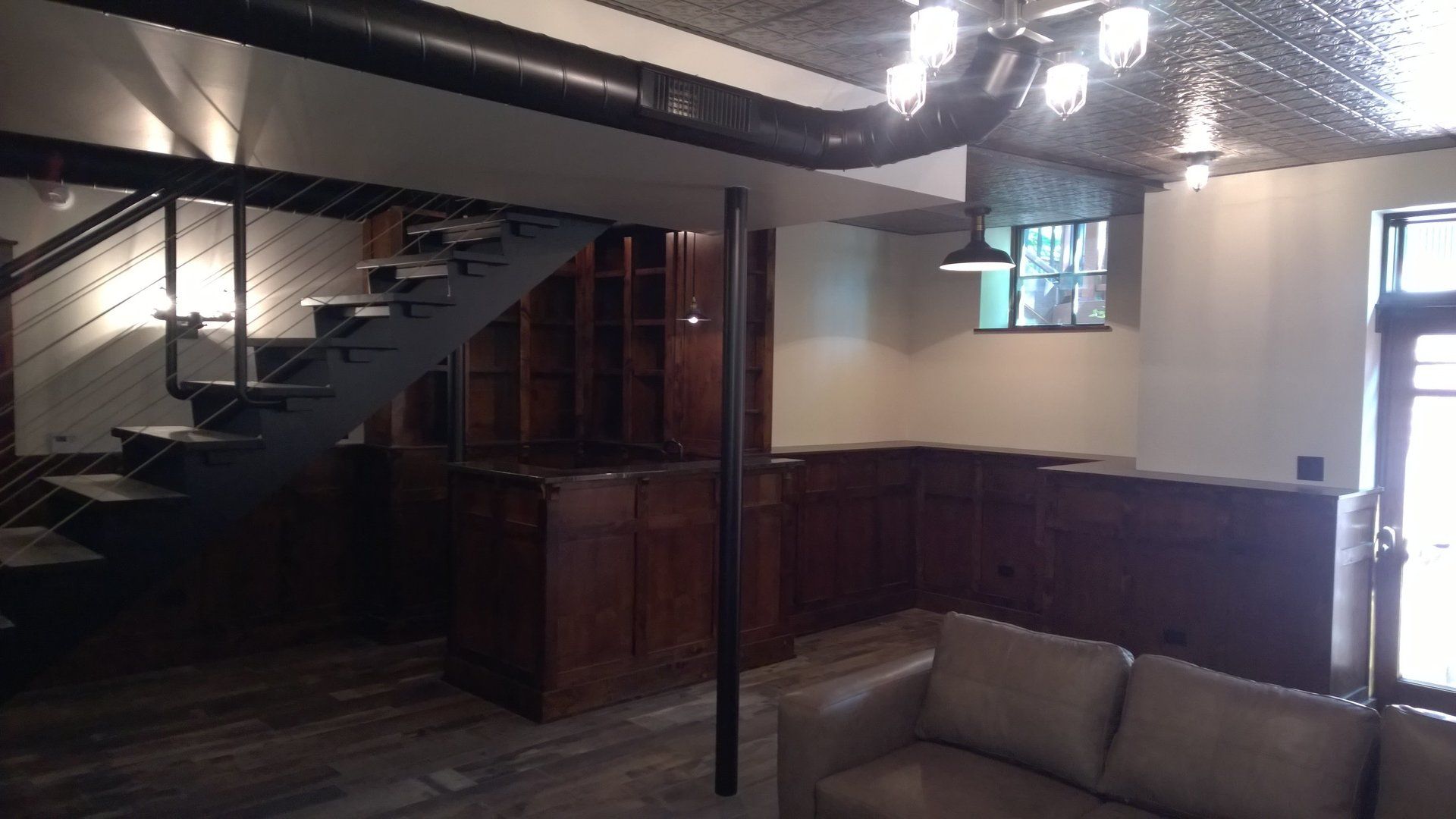 A living room with a staircase and a couch