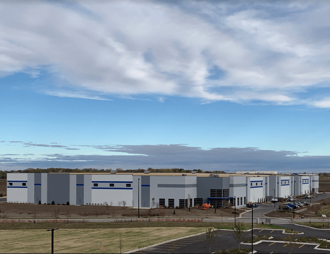 A large white building with a blue stripe on the side