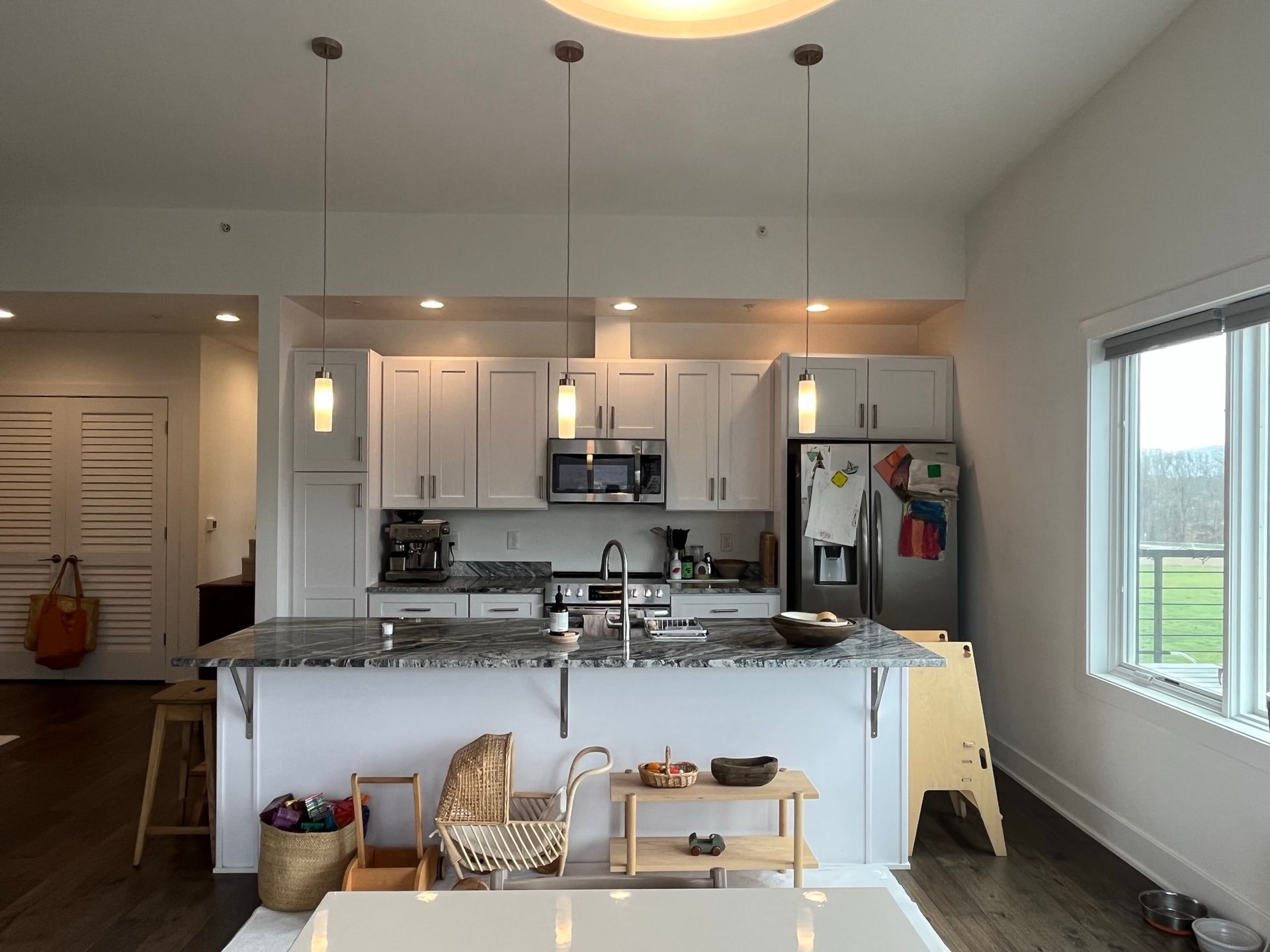 A kitchen with white cabinets and stainless steel appliances