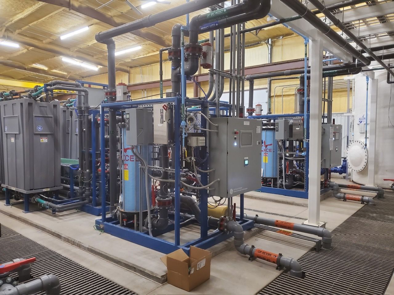 A large warehouse filled with lots of pipes and electrical equipment.