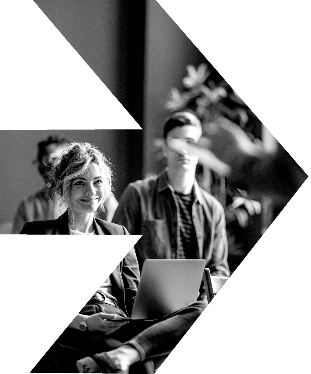 A man and a woman are sitting in front of a laptop computer.
