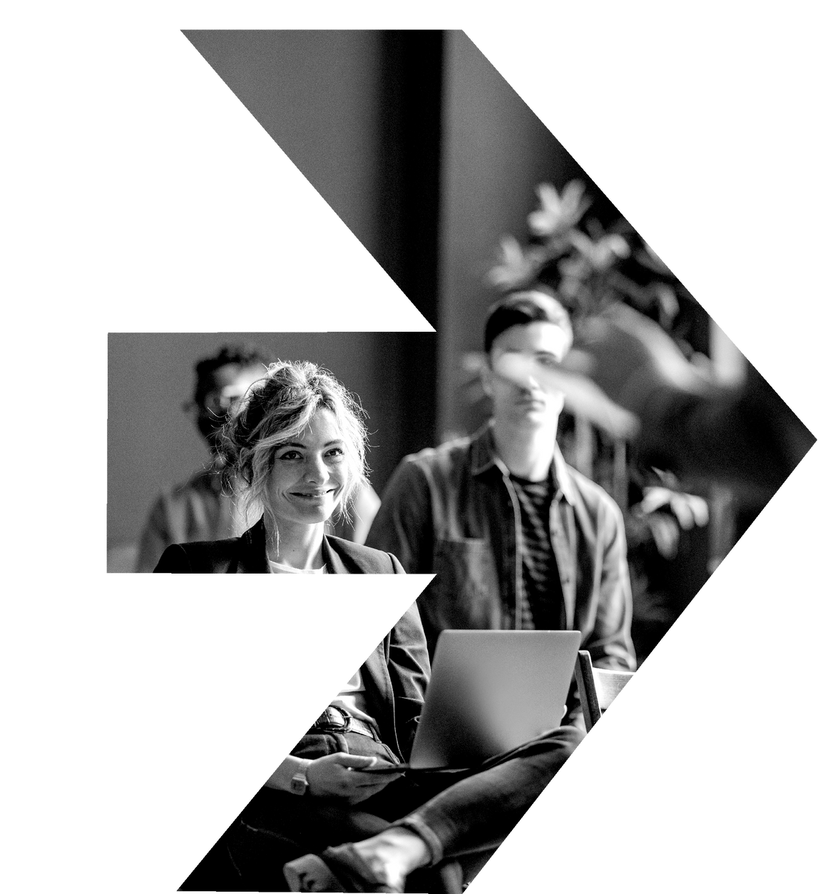 A woman is sitting in front of a laptop in a black and white photo.