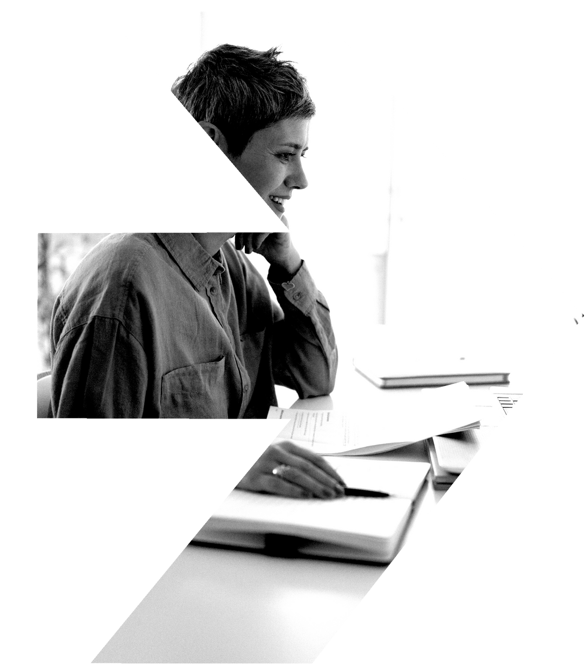 A black and white photo of a woman sitting at a desk