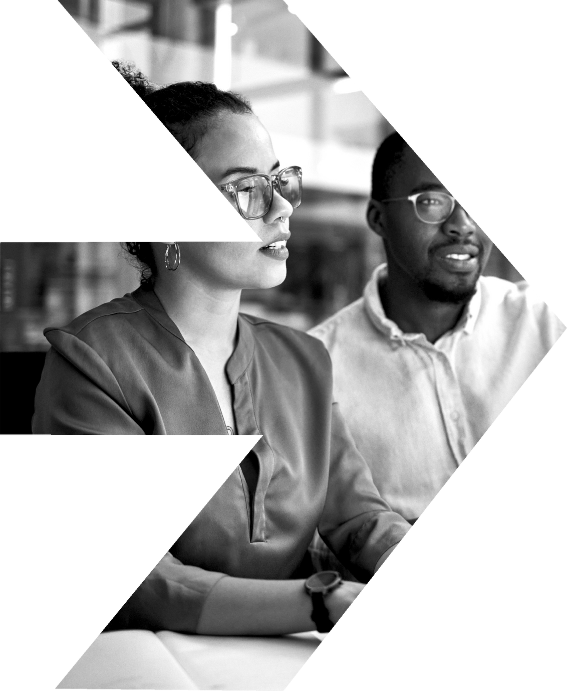 A man and a woman are sitting at a table in a black and white photo.