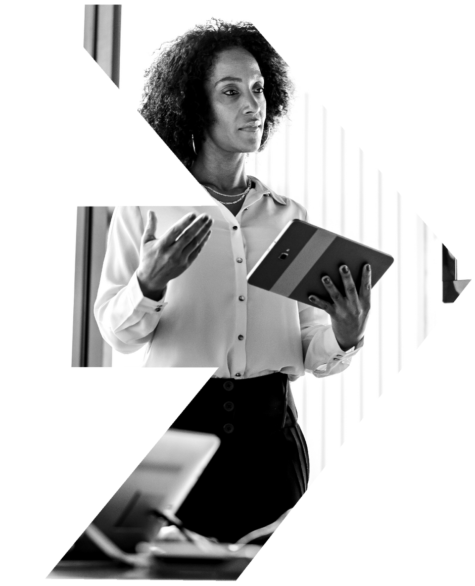A black and white photo of a woman holding a tablet.