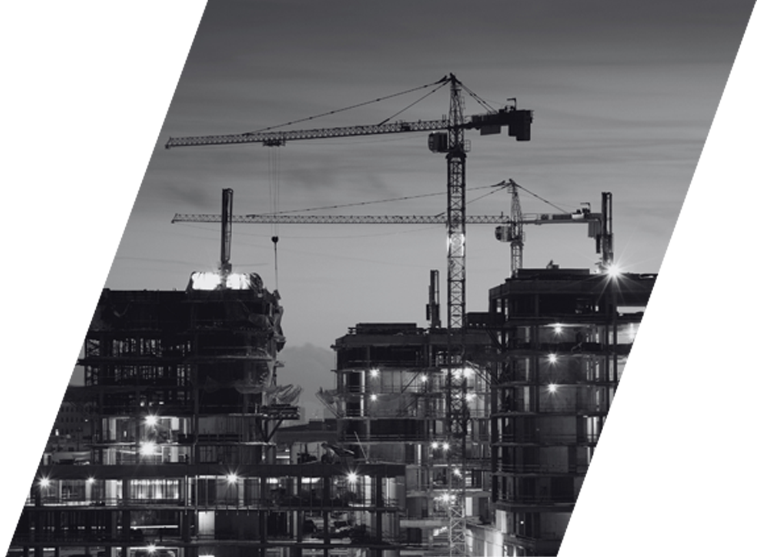 A black and white photo of a construction site at night