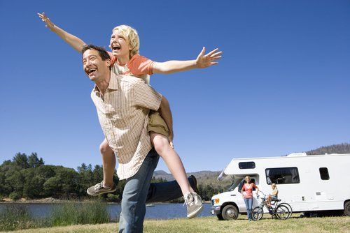 Happy family having a good time with motor home