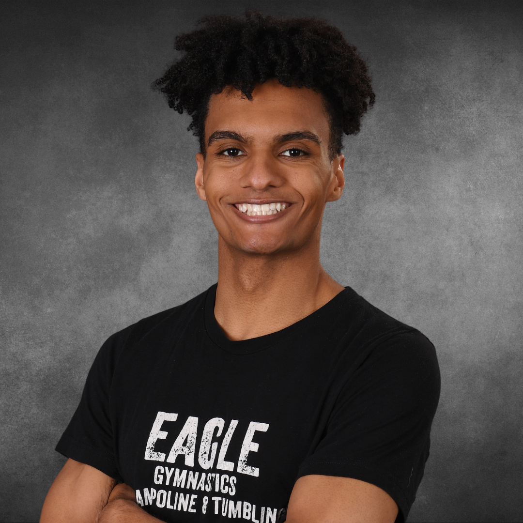 A young man is wearing an eagle gymnastics t-shirt