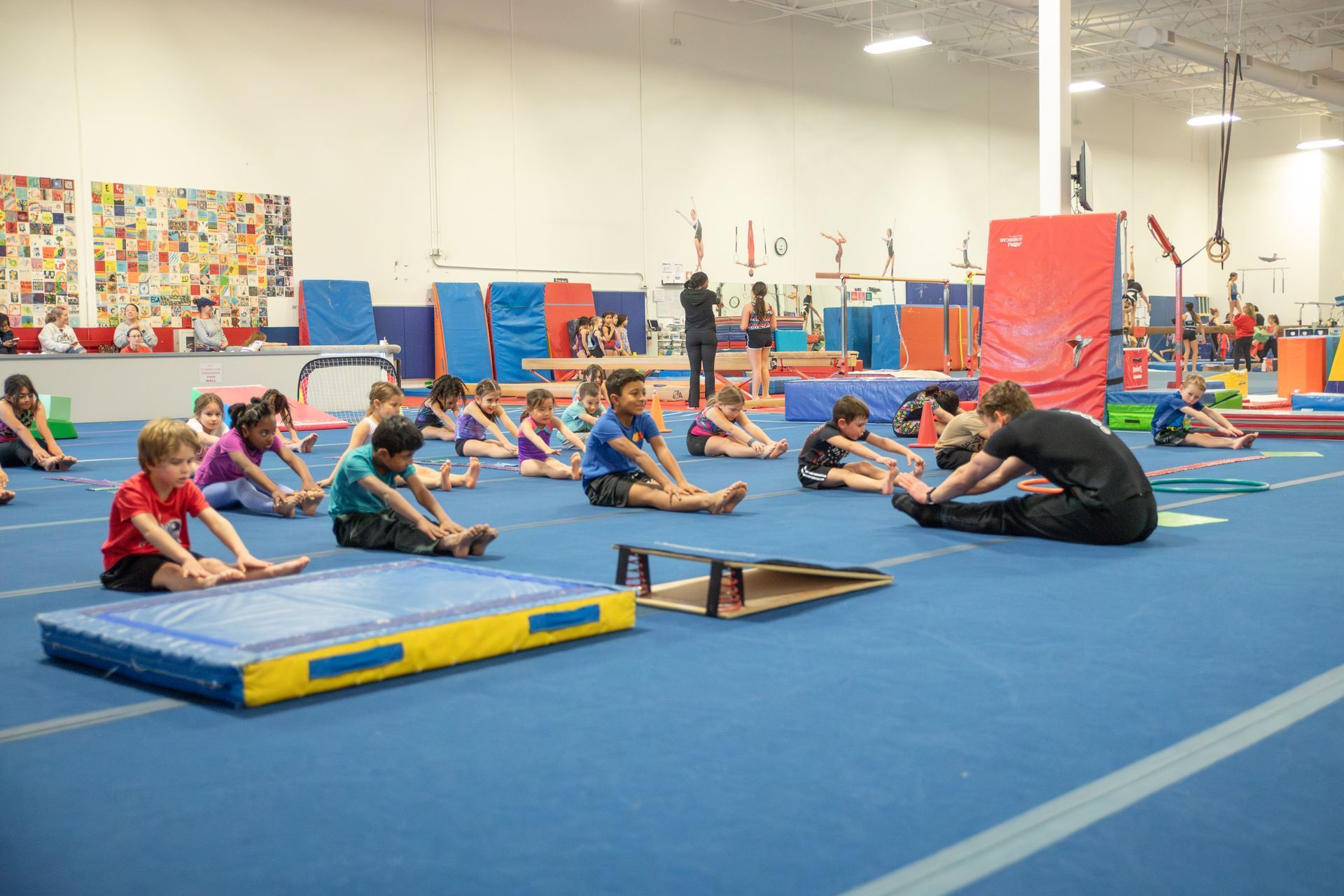 A group of female gymnasts are giving each other a high five.
