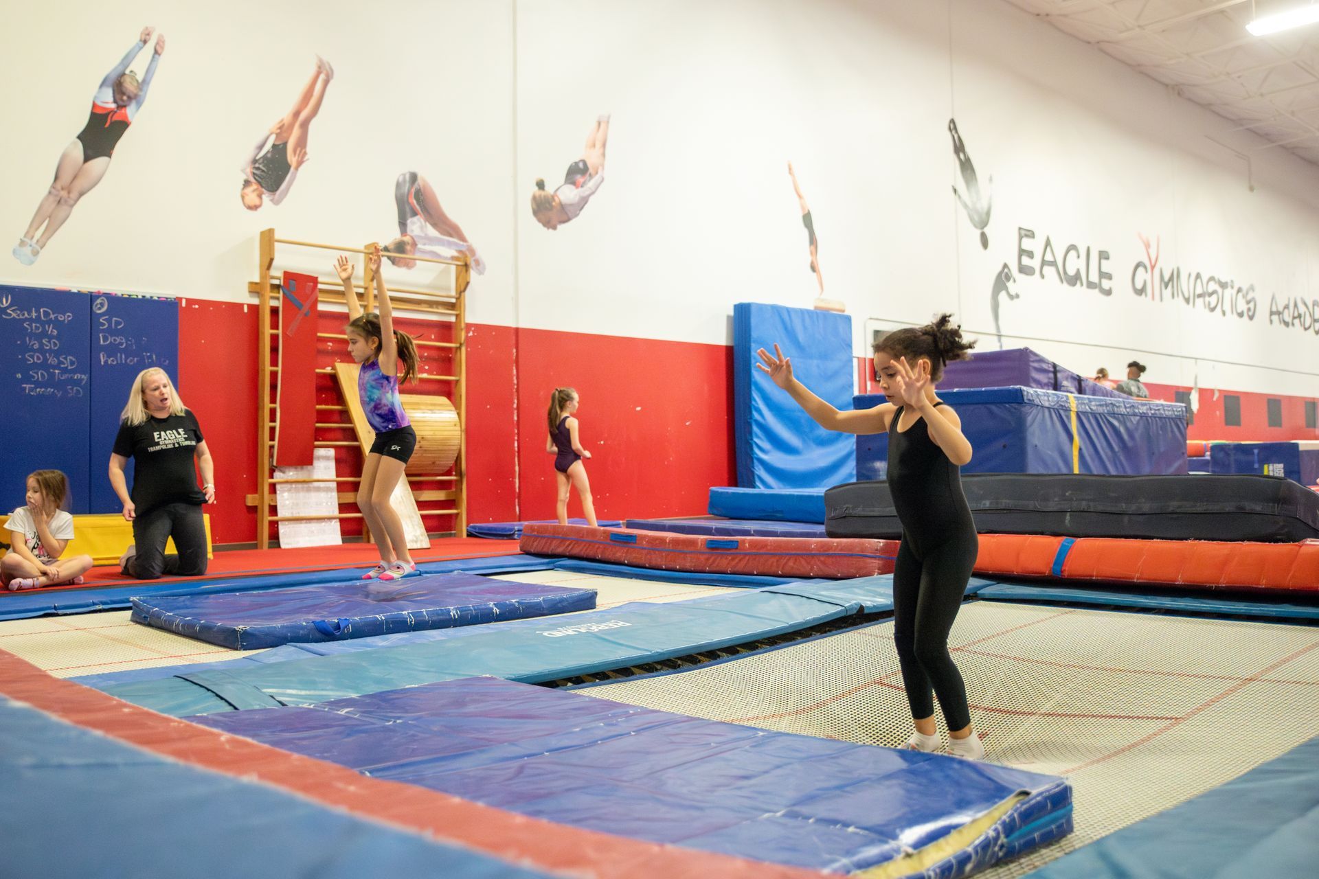 A man and a woman are standing next to each other on a balance beam.