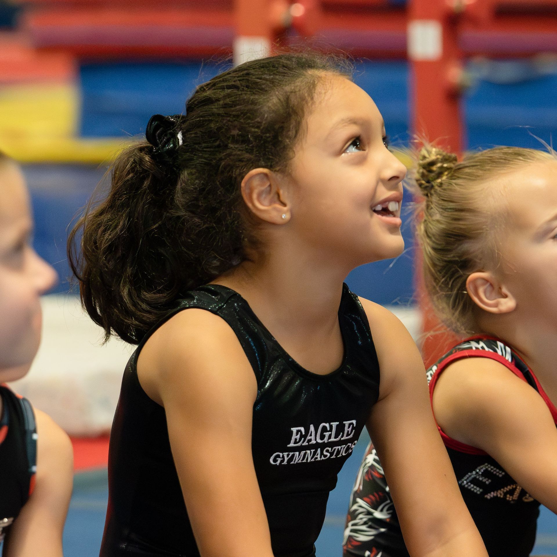 A girl wearing a black eagle gymnasts tank top