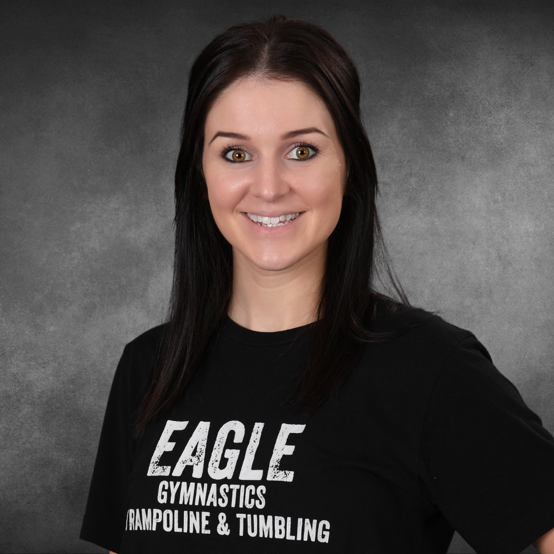 A woman wearing an eagle gymnastics trampoline and tumbling shirt