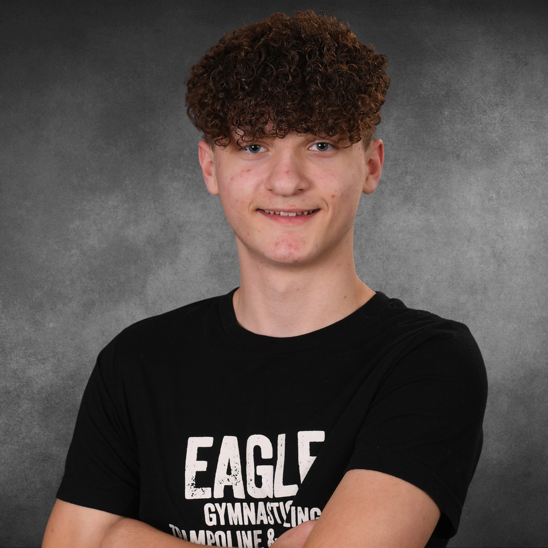 A young man wearing a black shirt that says eagle on it