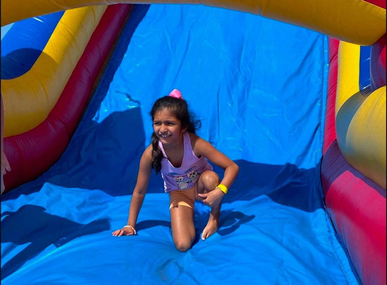 A group of young girls are posing for a picture in a gym.