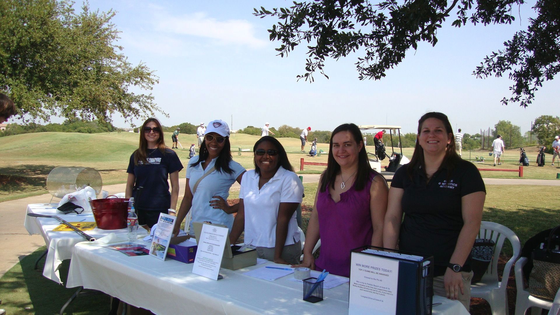 A group of women standing around a table with a sign that says free