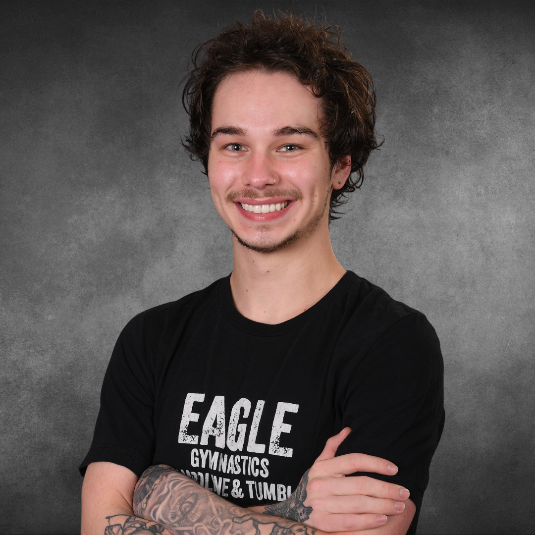 A young man wearing a black eagle gymnastics shirt